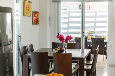 a kitchen and dining room with a table and chairs at Protaras Villa Dafni in Protaras
