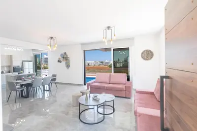 a living room with a couch and a table at Sol E Mar Villas ( Gold Emerging Villas ) in Protaras
