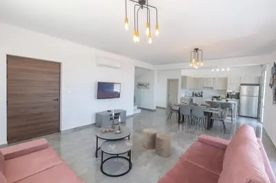 a living room with a couch and a table at Sol E Mar Villas ( Gold Emerging Villas ) in Protaras