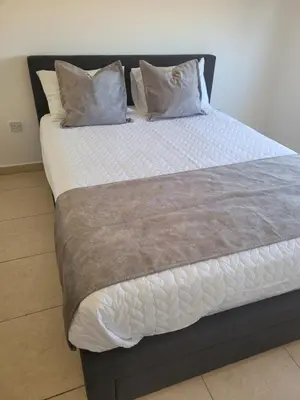 a large bed with two pillows on top of it at Cielo Apartment in Ayia Napa