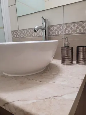 a white sink in a bathroom with a mirror at Cielo Apartment in Ayia Napa