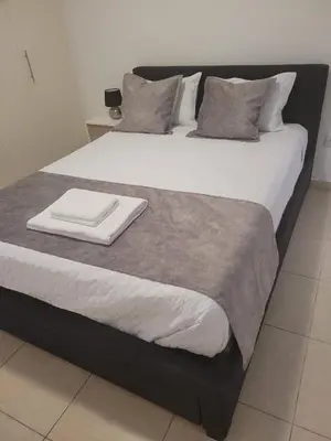 a large bed with two pillows on top of it at Cielo Apartment in Ayia Napa