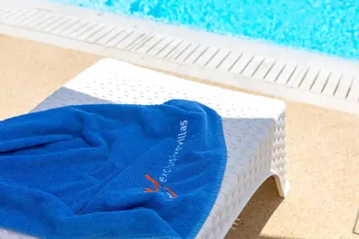 a blue towel is sitting on a mattress next to a swimming pool at Alasia Villas in Paralimni