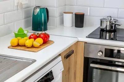 a kitchen counter with fruits and vegetables on a cutting board at Alasia Villas in Paralimni