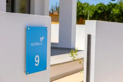 a sign for aiya up in front of a building at Alasia Villas in Paralimni