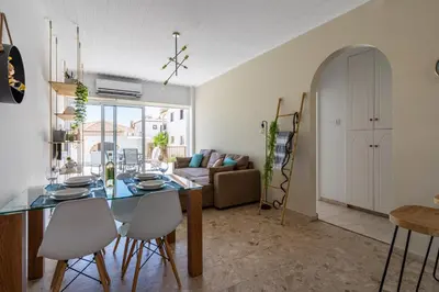 a kitchen and living room with a table and chairs at Keylana's 2-BR Apt in Pyla in Pyla