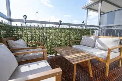 a patio with two chairs and a bench on a balcony at Napa Centrale Suites in Ayia Napa