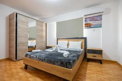 a bedroom with a bed with a white animal on it at Napa Centrale Suites in Ayia Napa