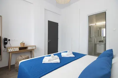 a bedroom with a blue bed with towels on it at Villa Queen Valentina in Protaras