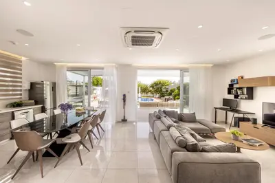 a living room with a couch and a table at Green Heaven Villa 3 in Protaras