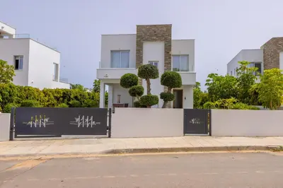 a house with a gate in front of a street at Green Heaven Villa 3 in Protaras