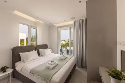 a bedroom with a bed with towels on it at Green Heaven Villa 3 in Protaras
