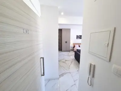 a hallway with a sliding door with a living room at Happy Homes Paradise in Larnaka