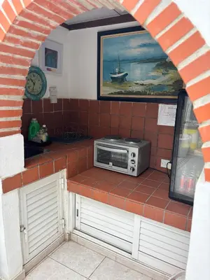 a microwave sitting on a counter in a kitchen at Mediterranean poolside garden cottage in Kiti