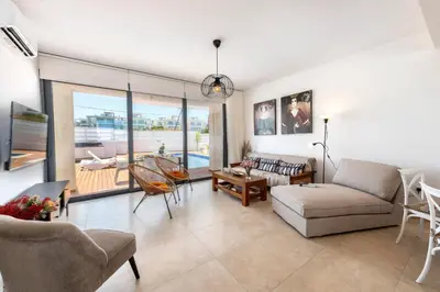 a living room with a couch and a table at Protaras Sol e Mar Villa 1 in Protaras