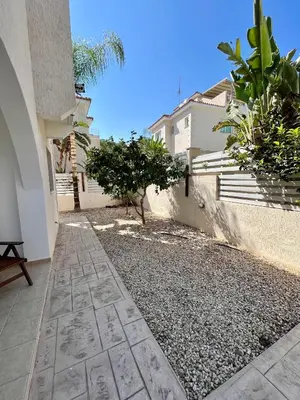a walkway in front of a building with a house at Villa Katia in Protaras