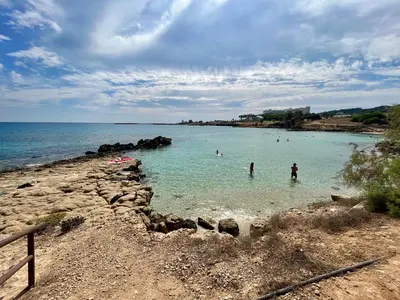 a group of people in the water at a beach at Villa Katia in Protaras
