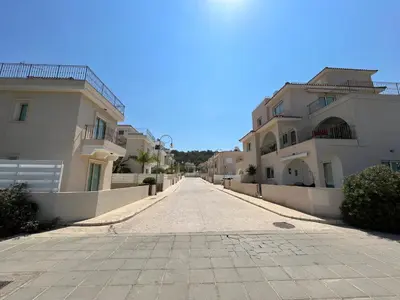 an empty street between two buildings on a clear day at Villa Katia in Protaras