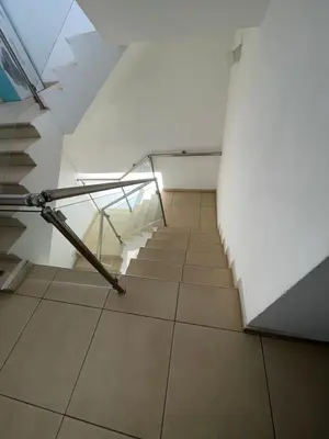 a staircase in an attic with a metal rail at Cielo Apartment No2 in Ayia Napa