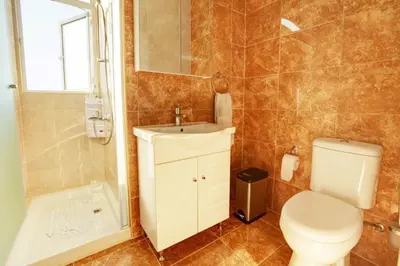 a bathroom with a toilet and a sink and a shower at Villa Mario - 2min walk from Kapparis Beach in Paralimni