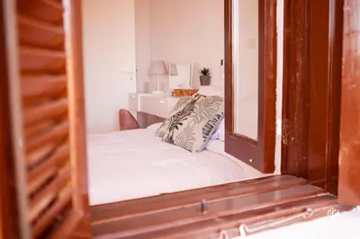 a small bedroom with a bed and a mirror at VINGT-DEUX Vouni 22 in Vouni
