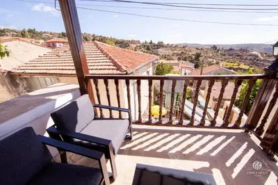 a balcony with chairs and a view of the city at VINGT-DEUX Vouni 22 in Vouni