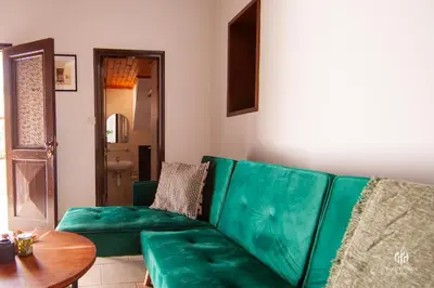 a green couch in a living room with a table at VINGT-DEUX Vouni 22 in Vouni