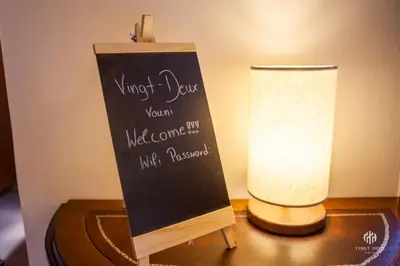 a table with a chalk board and a lamp at VINGT-DEUX Vouni 22 in Vouni