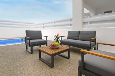 two chairs and a coffee table in a room at Villa Queen Isabella in Protaras