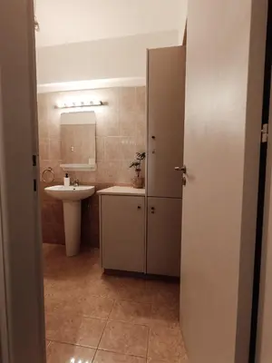 a bathroom with a sink and a toilet and a mirror at The Chalk in Larnaka