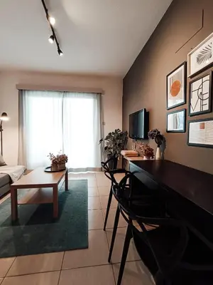 a living room with a desk and a table at The Chalk in Larnaka