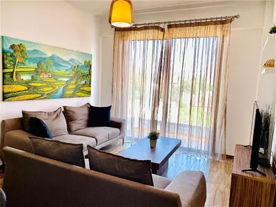 a living room with a couch and a table at BALI SUITES 202 in Larnaka
