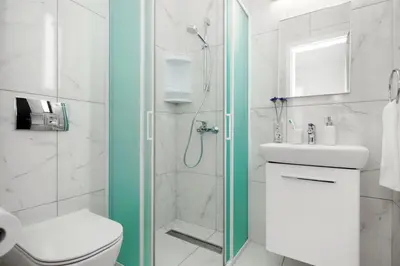 a bathroom with a shower and a toilet and a sink at Villa Queen Eleanor in Protaras