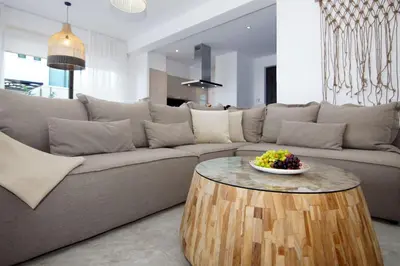 a living room with a couch and a table at Villa Queen Helena in Protaras