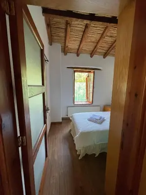 a bedroom with a bed and a window at Stone built country house in Louvaras Village in Louvaras