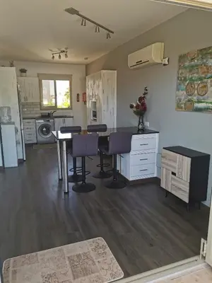 a kitchen with a table and chairs in a room at Sea view cosy apartment in Protaras