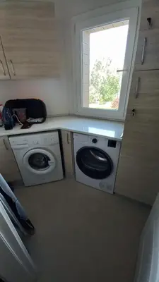 a kitchen with a washing machine and a window at Oytam apt in Nicosia