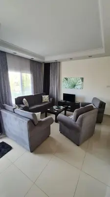 a living room with two couches and a tv at Oytam apt in Nicosia