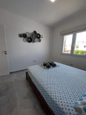 a bedroom with a bed in a room with a window at Amazing Napa Apartment in Ayia Napa