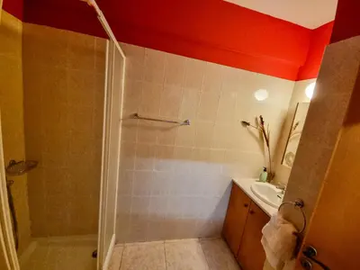 a bathroom with a shower and a sink at Dock Holiday Apartment in Larnaka