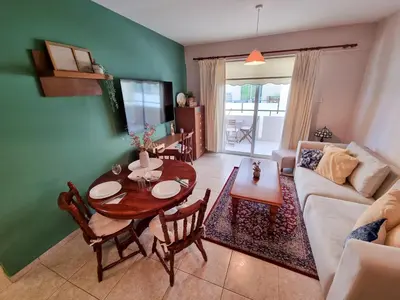 a living room with a table and a couch at Dock Holiday Apartment in Larnaka