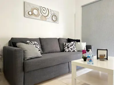 a living room with a gray couch and a table at Albert's apartment Marina 15 in Larnaka