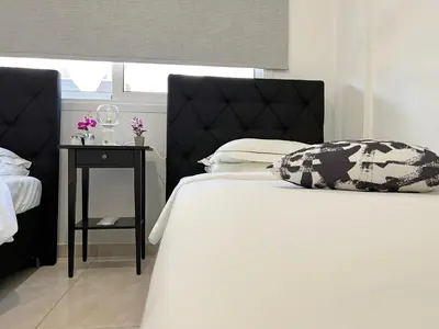 a bedroom with a bed and a nightstand with a bed sidx sidx at Albert's apartment Marina 15 in Larnaka