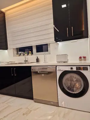 a kitchen with a washing machine and a sink at Sveltos Residence Suites in Larnaka