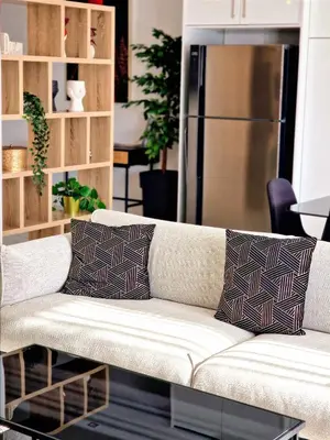 a white couch with two pillows sitting in a living room at Sveltos Residence Suites in Larnaka