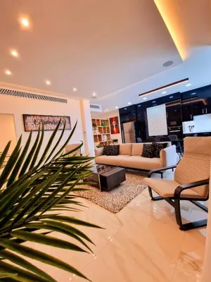 a living room with two couches and a palm tree at Sveltos Residence Suites in Larnaka