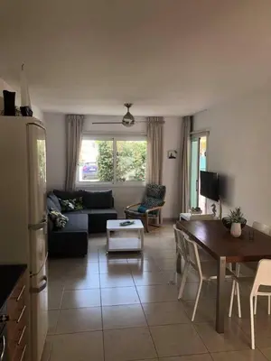 a living room with a couch and a table at Yiasemi Ground floor Holiday Appartment in Paralimni