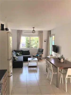 a living room with a couch and a table at Yiasemi Ground floor Holiday Appartment in Paralimni