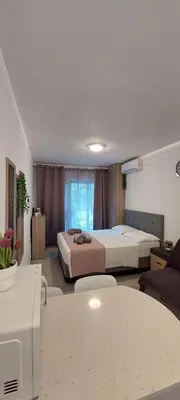 a hotel room with two beds and a table at Stay With Oleg C17 in Paralimni