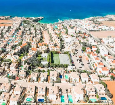 an aerial view of a town next to the ocean at Villa Pant Poly in Protaras